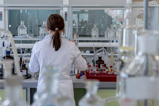 mulher de costas fazendo experimentos em um laboratório